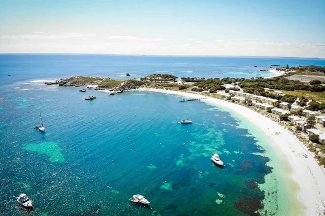Turquoise bay with moored boats and white sand on Rottnest Island